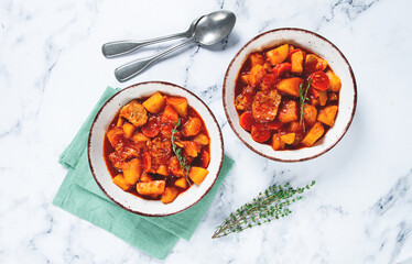 meat goulash with potatoes and carrots, sweet peppers, in a saucepan, top view, traditional Hungarian soup, homemade, no people,