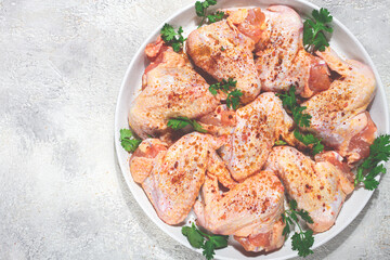 Marinated chicken wings prepared for grilling with spices and fresh herbs ready for cooking