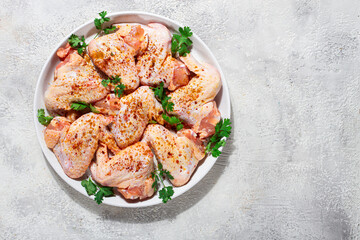 Marinated chicken wings prepared for grilling with spices and fresh herbs ready for cooking