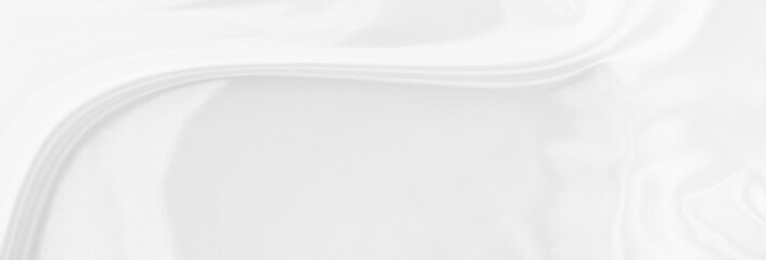 White gray satin texture that is white silver fabric silk panorama background with beautiful soft blur pattern natural.