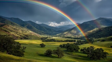 Obraz premium Majestic Landscape with Double Rainbow Over Green Valley and Mountains