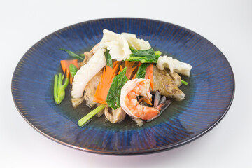 Rad Na Talay or Fried Noodles with Seafood Which consists of squid and shrimp in Thick Gravy Sauce on white background , Thai Style food