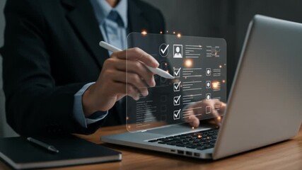 Man in suit using laptop with digital checklist interface and stylus on wooden desk in office setting - Powered by Adobe