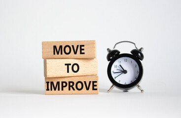 Move to Improve symbol. Concept words Move to Improve on wooden blocks. Beautiful white background...