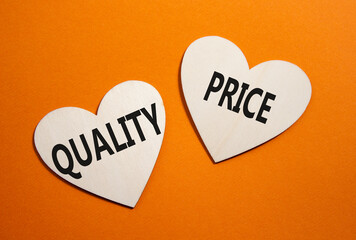 Price or Quality symbol. Concept word Price or Quality on wooden hearts. Beautiful orange...
