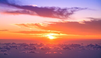 Obraz premium Aerial view of a vibrant sunset over a sea of clouds