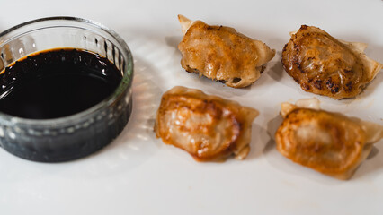 Delicious fried juicy dumpling (gyoza) glazed with rich tare sauce or soy sauce, crispy on the...