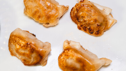 Delicious fried juicy dumpling (gyoza) glazed with rich tare sauce or soy sauce, crispy on the...