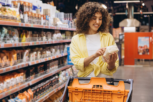 Woman Choosing Food in Supermarket Reading Product Label