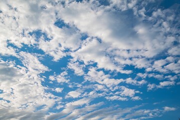Beautiful cloud formations in a clear blue sky during daytime across the horizon