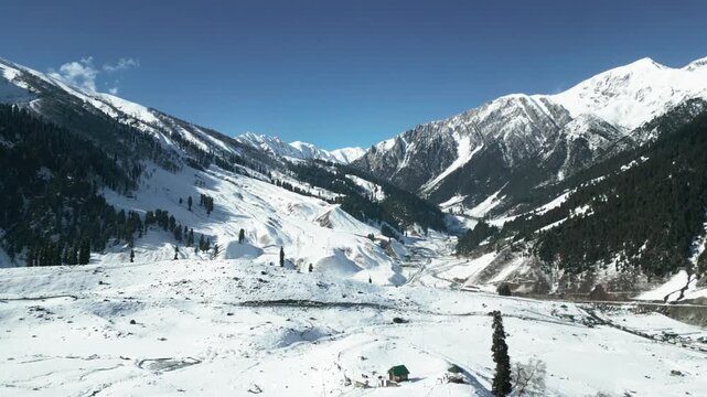 Drone shot capturing the frozen beauty of Thajiwas in Sonmarg, where snowy meadows stretch endlessly under the winter sun.