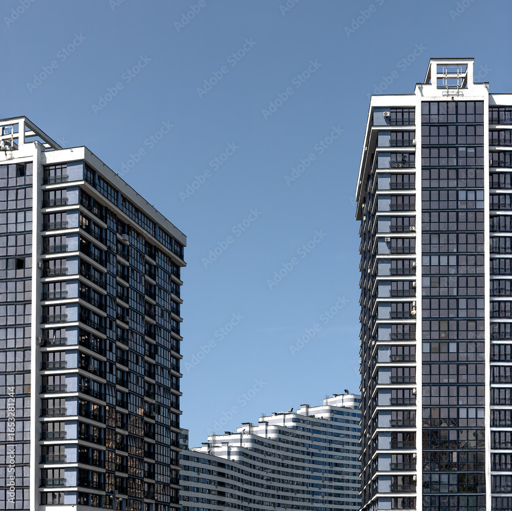 Poster building frames the clear sky of a modern metropolis. tall concrete multistory block with patterned