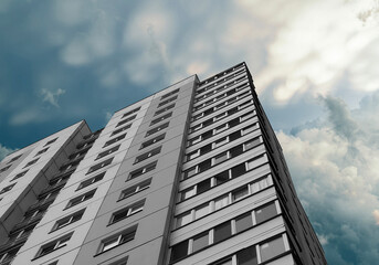 Building rises under sunny sky. Modern highrise architecture showcases concrete multistorey block