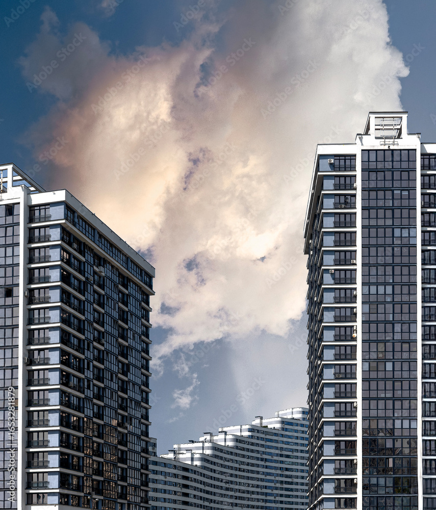 Poster building stands tall under cloudy sky. modern concrete multistorey block features patterned window