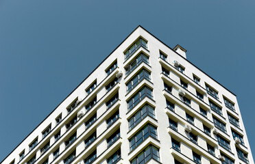 Obraz premium Building. Modern concrete highrise architecture showcases patterned multistory facade, tall