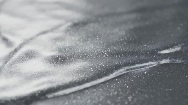 Abstract Silver Liquid Metal Waves - Close-up view of shimmering silver liquid metal forming abstract waves.