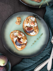 Fig and Goat Cheese Toasts with Cutlery on Green Kitchen Towel