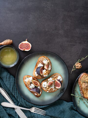 Vertical Top View of Three Fig and Goat Cheese Toasts with Honey and Cutlery