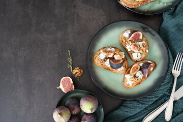 Three Fig and Goat Cheese Toasts with Cutlery on Green Plate