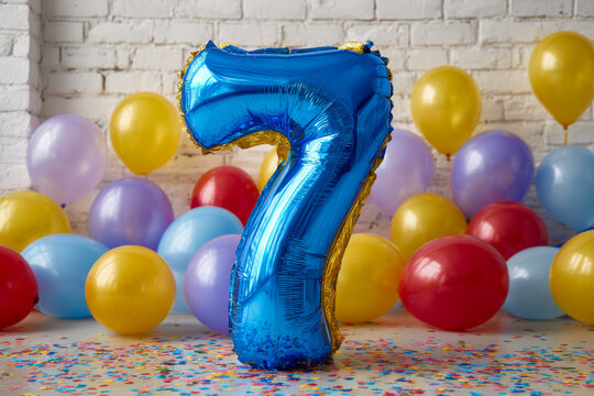 Bright blue number seven balloon surrounded by colorful balloons and confetti for celebration