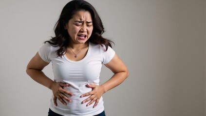Woman clutching stomach in pain captures relatable moment of physical distress