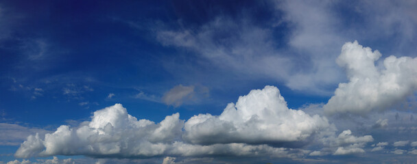 blue sky with fluffy white clouds, wide panorama