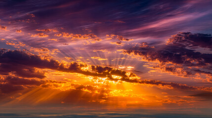 Fototapeta premium Vibrant sunset with dramatic cloud formations and radiant light beams breaking through the colorful sky
