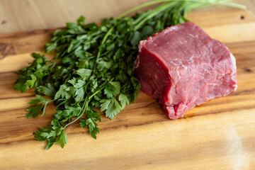 close up fresh fillet on wooden cutting board, raw red meat in kitchen, dishes with meat