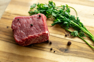 close up fresh fillet on wooden cutting board, raw red meat in kitchen, dishes with meat