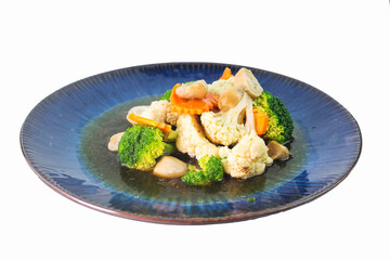 Stir-fried mixed vegetables with broccoli, cauliflower, carrots and straw mushrooms isolated on white background