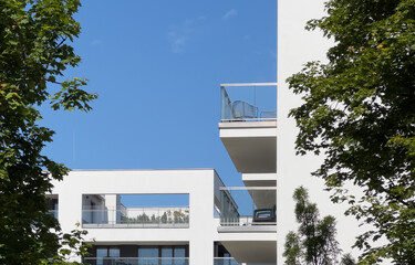 Residential building rises with elegant balconies. Modern urban condominium architecture showcases