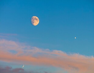 Pale moon and crescent moon in pastel sky