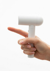 Hand holding a white portable handheld device with a finger pointing