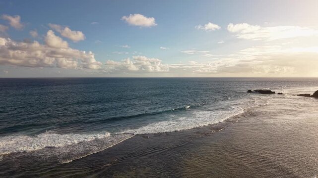 Drone panorama shows long reef lines clear shallows and small rock ledge off Saint Felix peaceful shoreline