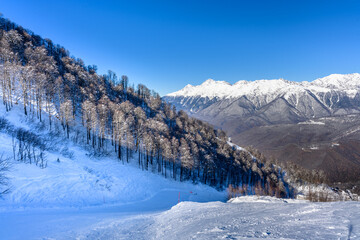 A beautiful winter landscape with a mountain resort and snow on the slopes.