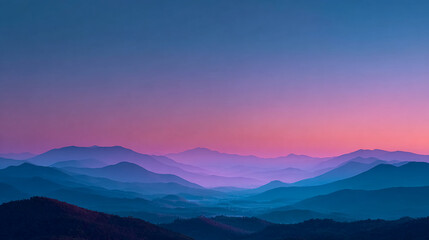 Obraz premium Layered Mountains glow at sunset. Perfect for backgrounds, editorial, or marketing material relating to travel, nature, and outdoors.