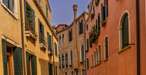 Venetian houses with brick walls and arched windows