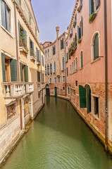 Venetian canals with boats and reflections