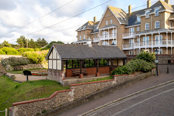 Small public shelter and historic period buildings in the seaside town of Cromer, Norfolk coast