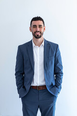 Handsome, bearded young business man with blue jacket and hands in pockets