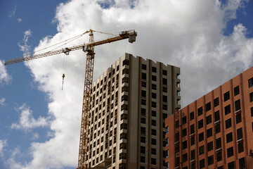 Construction of new residential buildings. Unfinished houses on the construction site.