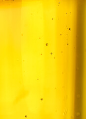 Golden beer close-up with bubbles in glass