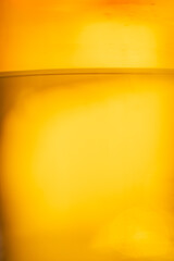 Golden beer close-up with bubbles in glass