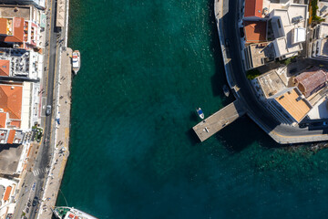 Aerial view of Agios Nikolaos, Crete, Greece, showing turquoise waters, red tiled roofs,...