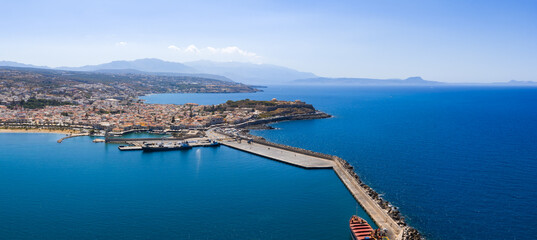 Aerial view of Rethymno town in Crete, Greece, featuring terracotta roofed buildings, the Venetian...