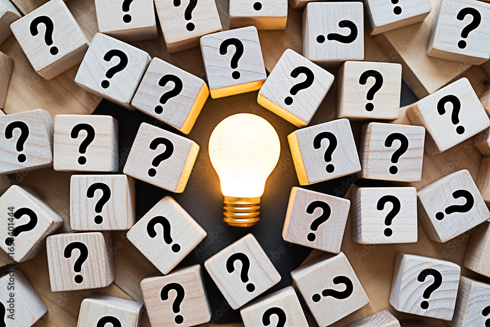 Poster questions and answers concept ideas lightbulb surrounded by question marks on wooden blocks backgrou