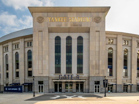 Bronx, NY - US - Aug 16, 2025 The iconic facade of Yankee Stadium's Gate 4, a grand entrance with "YANKEE STADIUM" prominently displayed and a large "GATE 4" sign below.