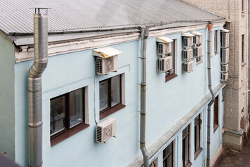 Air conditioners are installed on the facade of the building. device for comfortable living in hot...