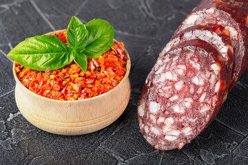 dry sausage sliced with spices and basil