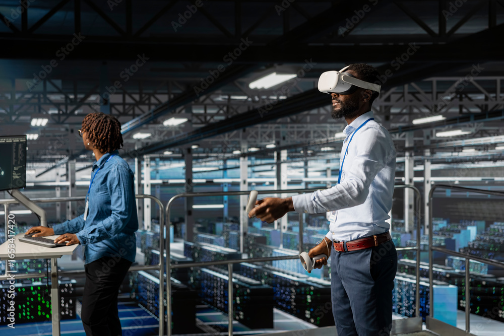 Poster black male it expert uses vr glasses on industrial platform in server room, using high tech tools to